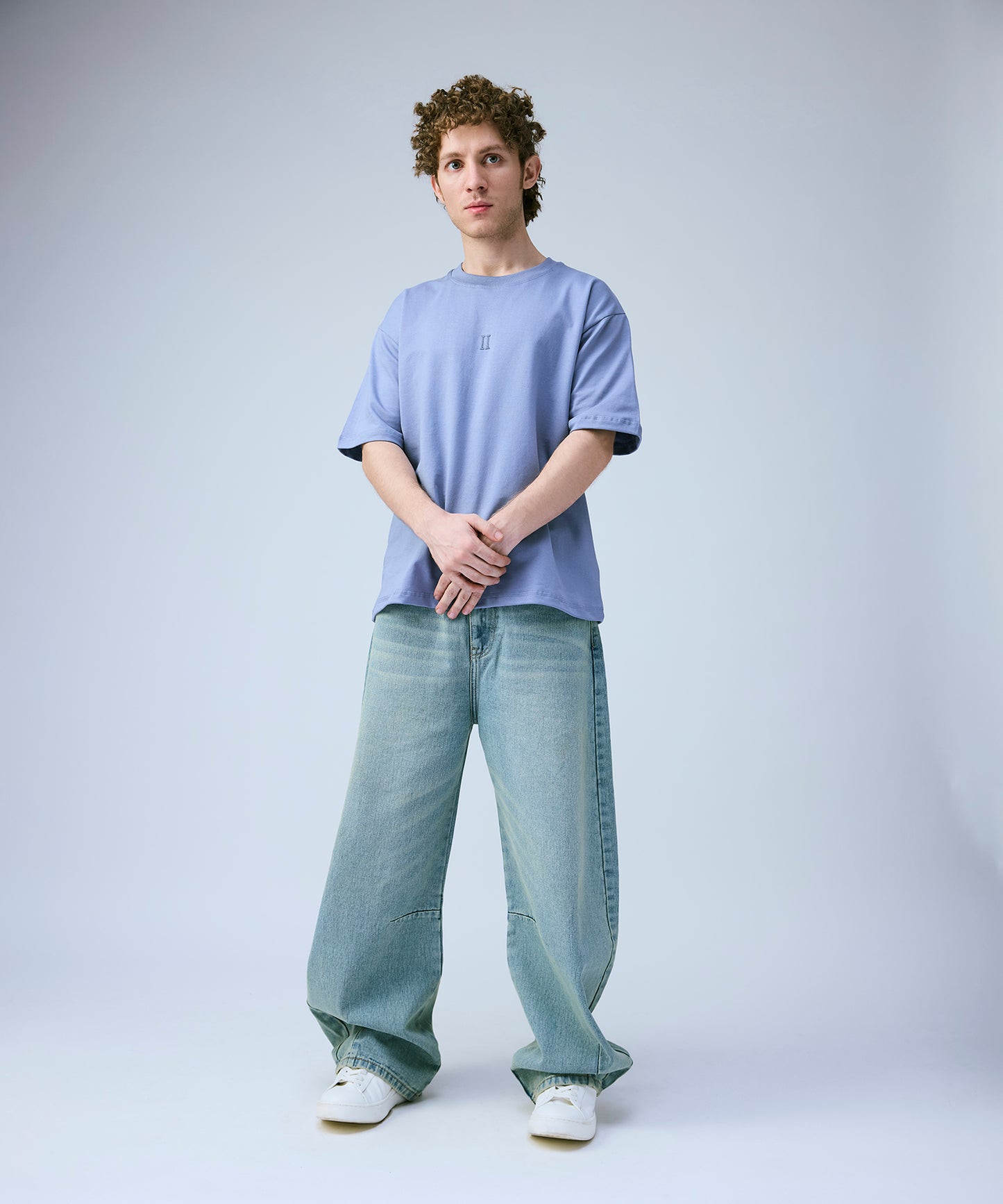 light blue t-shirt and jeans on a plain background